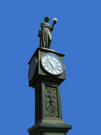 Old town clock and statue.の写真素材