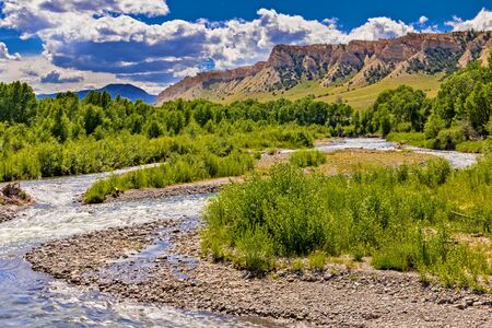Wyoming River with mountains in the backgroundの写真素材