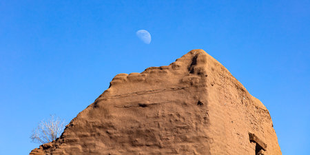 Moon and sandstone desert landscape in Pecos Pueblo National Monument New Mexico, USAの写真素材