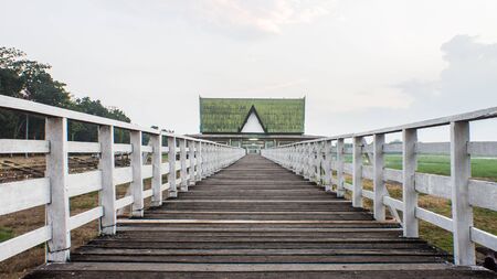 The Wood bridge cross over water to the templeの写真素材
