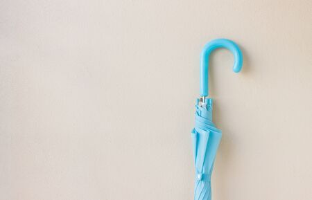 The blue umbrella in hand on the white backgroundの写真素材