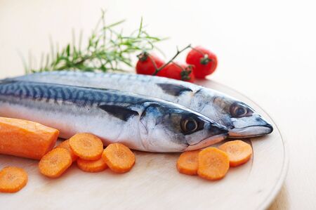 Two mackerel fish with different vegetablesの写真素材