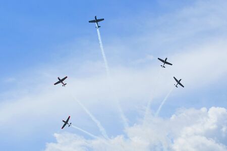  Group of old timer planes performing acrobatics in the air の写真素材