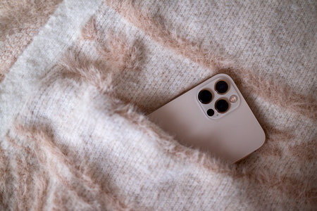 Smartphone in the pocket of the cardiganの写真素材