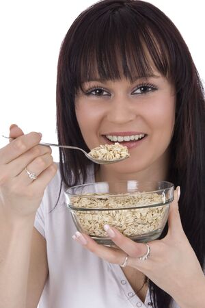 Woman eats cereals from saucerの写真素材