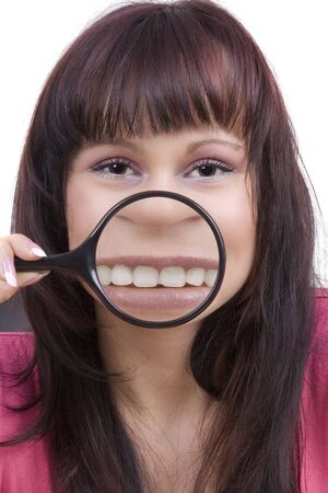 Woman with magnifying glass against a white backgroundの写真素材