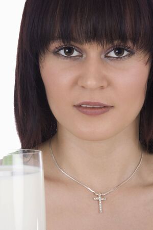 Woman with a glass of milk against a white backgroundの写真素材