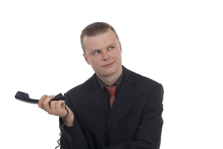 Frustrated dealer in phone receiver against a white background の写真素材