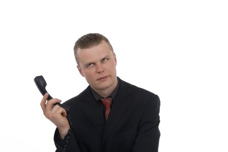 Frustrated dealer in phone receiver against a white background の写真素材