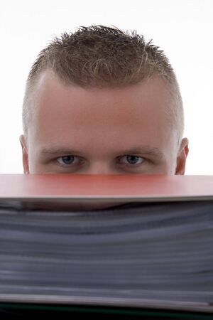 Man stashed  behind foldersBusinessman with folders, indicant fingerの写真素材