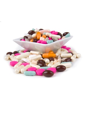 Pills in saucer  on white background.の写真素材