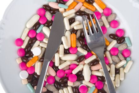 Pharmaceuticals on plate ready to food/illustrative presume medicine/against egg white background. の写真素材