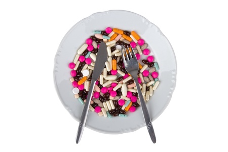 Pharmaceuticals on plate ready to food/illustrative presume medicine/against egg white background. の写真素材