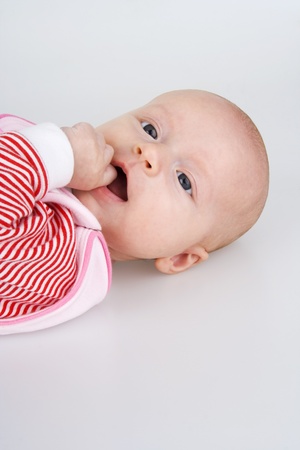 Child recumbent piggyback on white background.の写真素材
