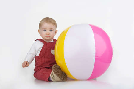 Child with beach ball on white background.の写真素材
