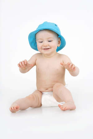 Merry child in blue hat on white background.の写真素材