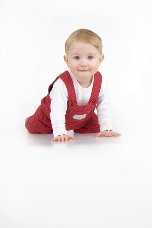 Toddling child on white background.の写真素材