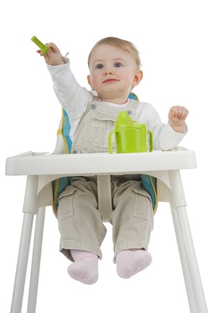 Child on child's stool with potty and teaspoon on white background.の写真素材