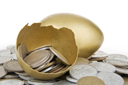 Broken gold egg and old money,on white background.の写真素材