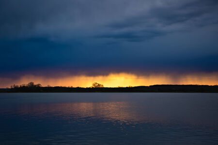 Summer evening by a lake and still waterの写真素材