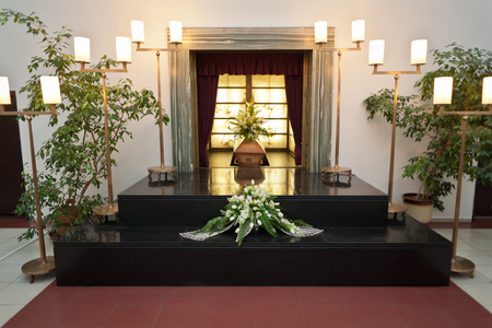 Wooden coffin with funeral flowers in crematoriumのeditorial素材