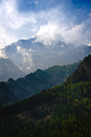 Morning in mountains with fog and clouds during sunriseの写真素材