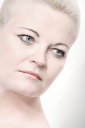 Portrait of beautiful woman with short blond hair on white with soft make-upの写真素材