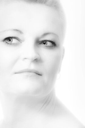 Portrait of beautiful woman with short blond hair on white with soft make-upの写真素材