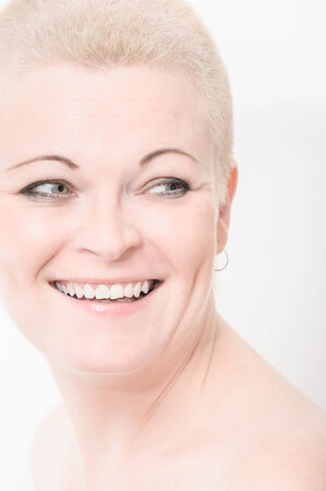 Portrait of beautiful woman with short blond hair on white with soft make-upの写真素材