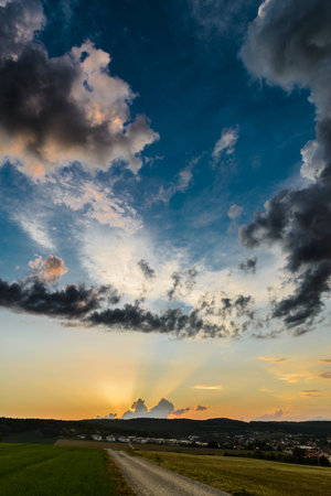 Sunrise in the rural outdoor with beautiful clouds over a small villageの写真素材