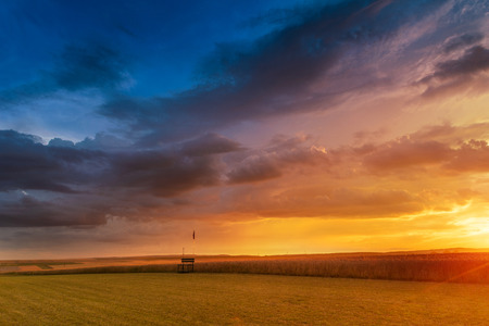 Sunset in fields in Central Europe with heavy cloudsの写真素材
