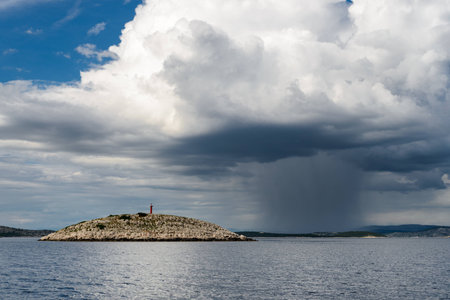 Deserted island in Adriatic with rain storm in backgroundの写真素材