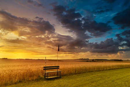 Sunset in fields in Central Europe with heavy cloudsの写真素材