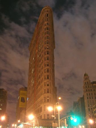 Flatron building by cloudy night - New York.