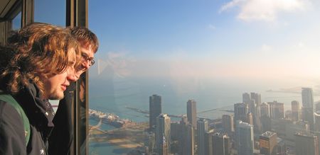 Two young boy tourist looking on the Chicago bay from John Hancock Building - Chicago - United...