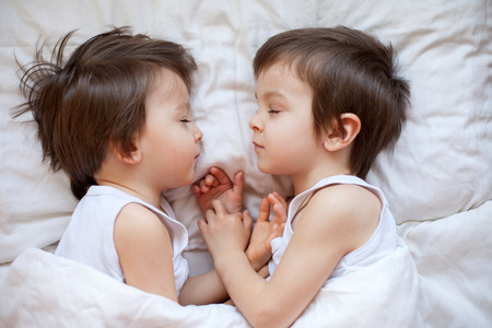 Two little boys, brothers, sleeping in the afternoon の写真素材