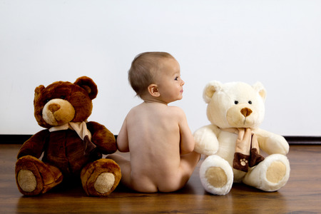 Cute naked boy with teddy bearsの写真素材