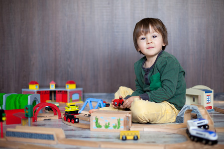 Little toddler boy playing with wooden railway, indoors. の写真素材