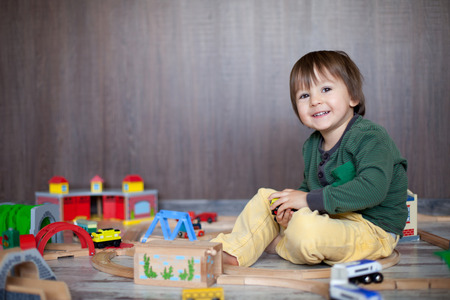 Little toddler boy playing with wooden railway, indoors. の写真素材