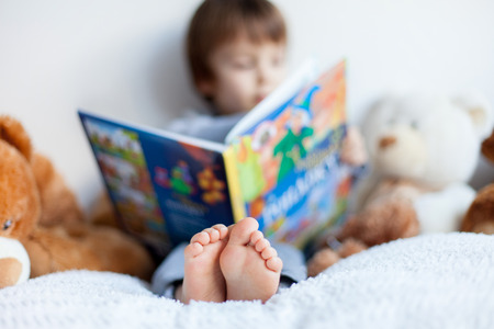Boy, reading a book, educating himself の写真素材