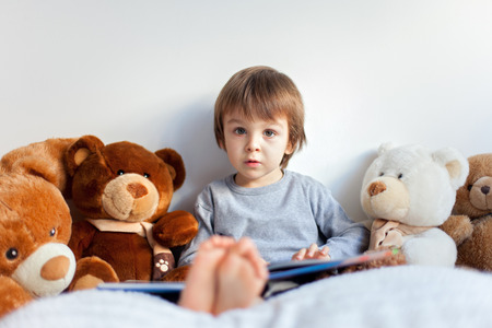 Boy, reading a book, educating himself の写真素材