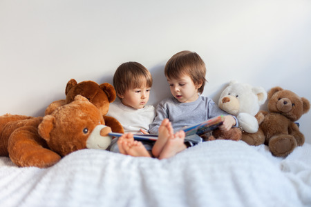 Two boys, reading a book, educating themselvesの写真素材