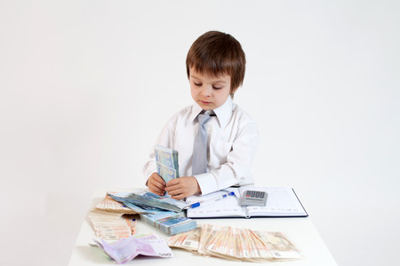 Young man, counting money and taking notesの写真素材
