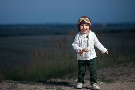 Boy, playing with a wooden planeの写真素材