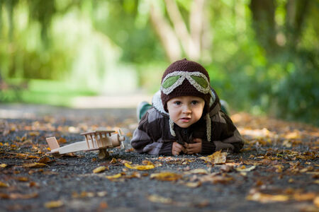 Boy imagines discovery adventure with a plane in the parkの写真素材