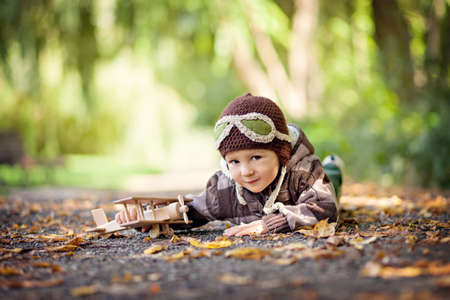 Boy imagines discovery adventure with a plane in the parkの写真素材
