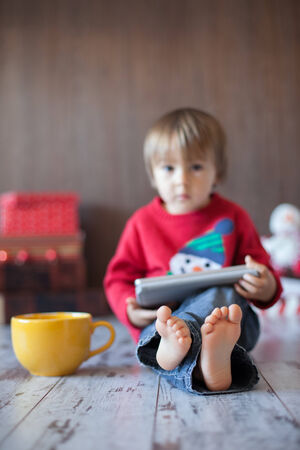 Little boy, playing on tablet の写真素材