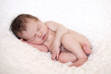 Adorable baby boy, sleeping on white backgroundの写真素材
