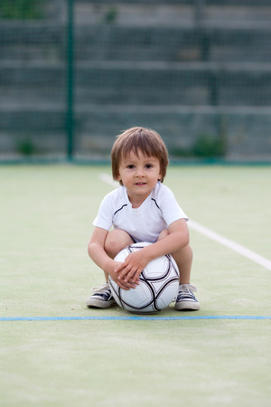 Cute little boy, playing footballの写真素材