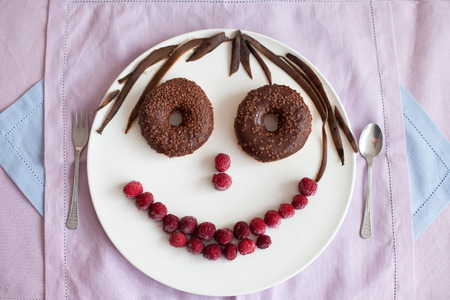 Chocolate donuts with raspberriesの写真素材